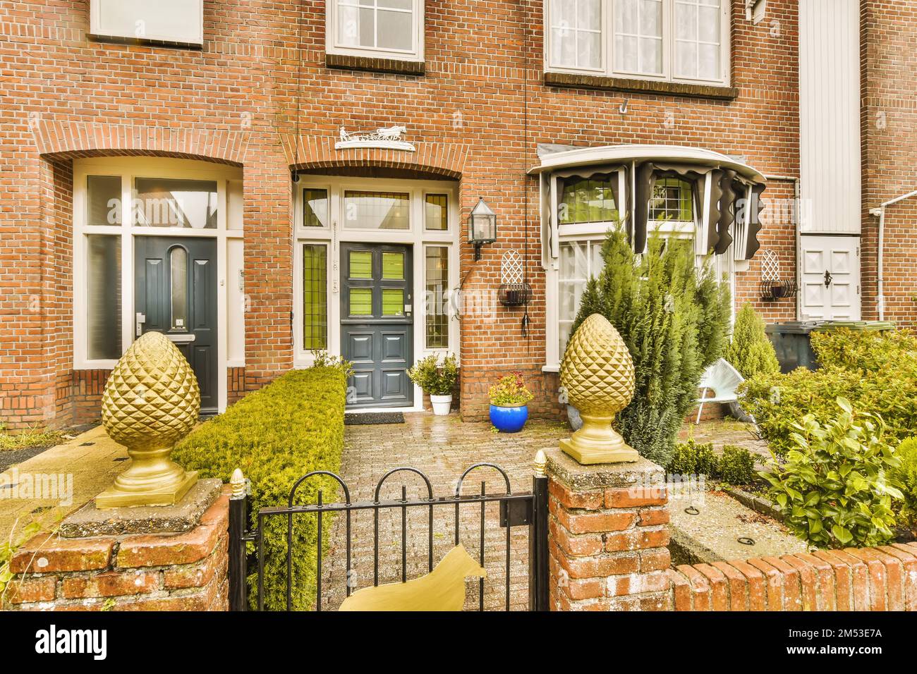 an outside view of a house with brick walls and plants in the front