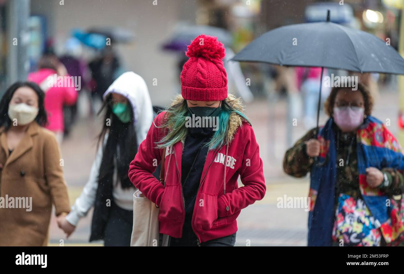 People wear thick clothes against the cold weather at Tsim Sha Tsui