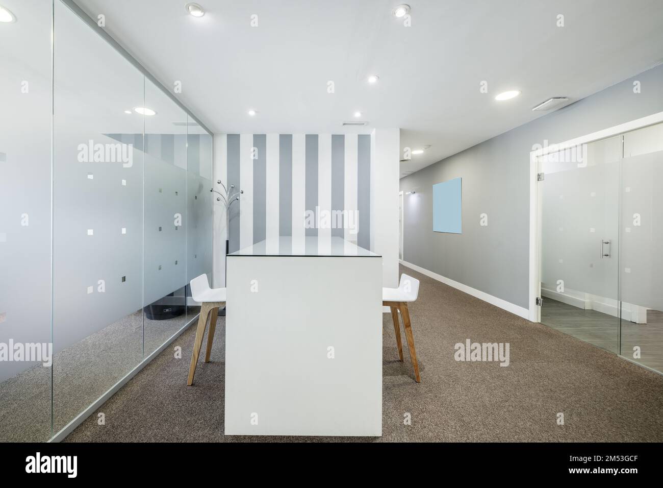 Reception desk of an office office with glass partitions and carpeted floors Stock Photo Alamy