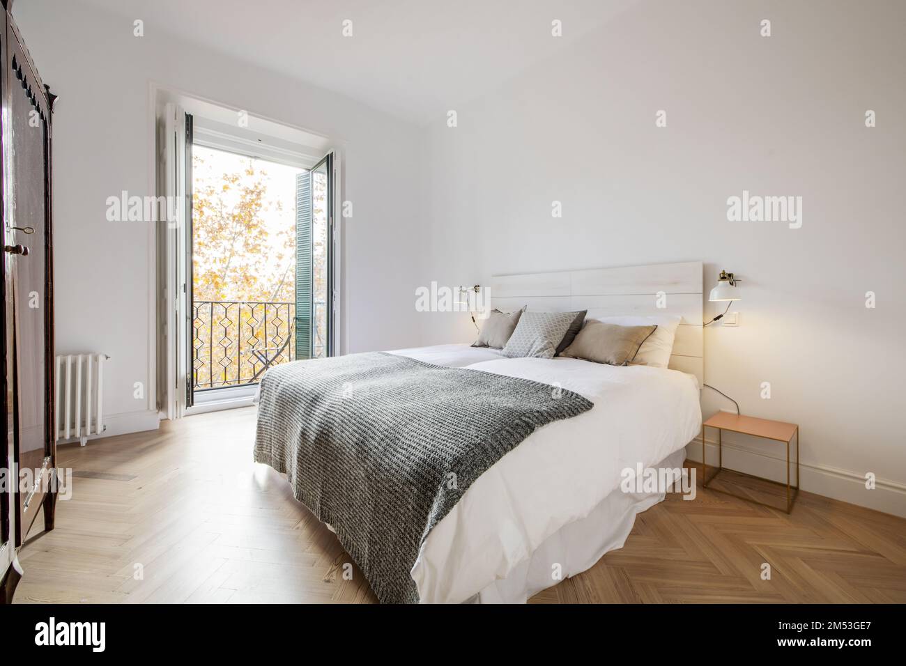 Double bedroom with queen size bed, wooden bedside tables, balcony