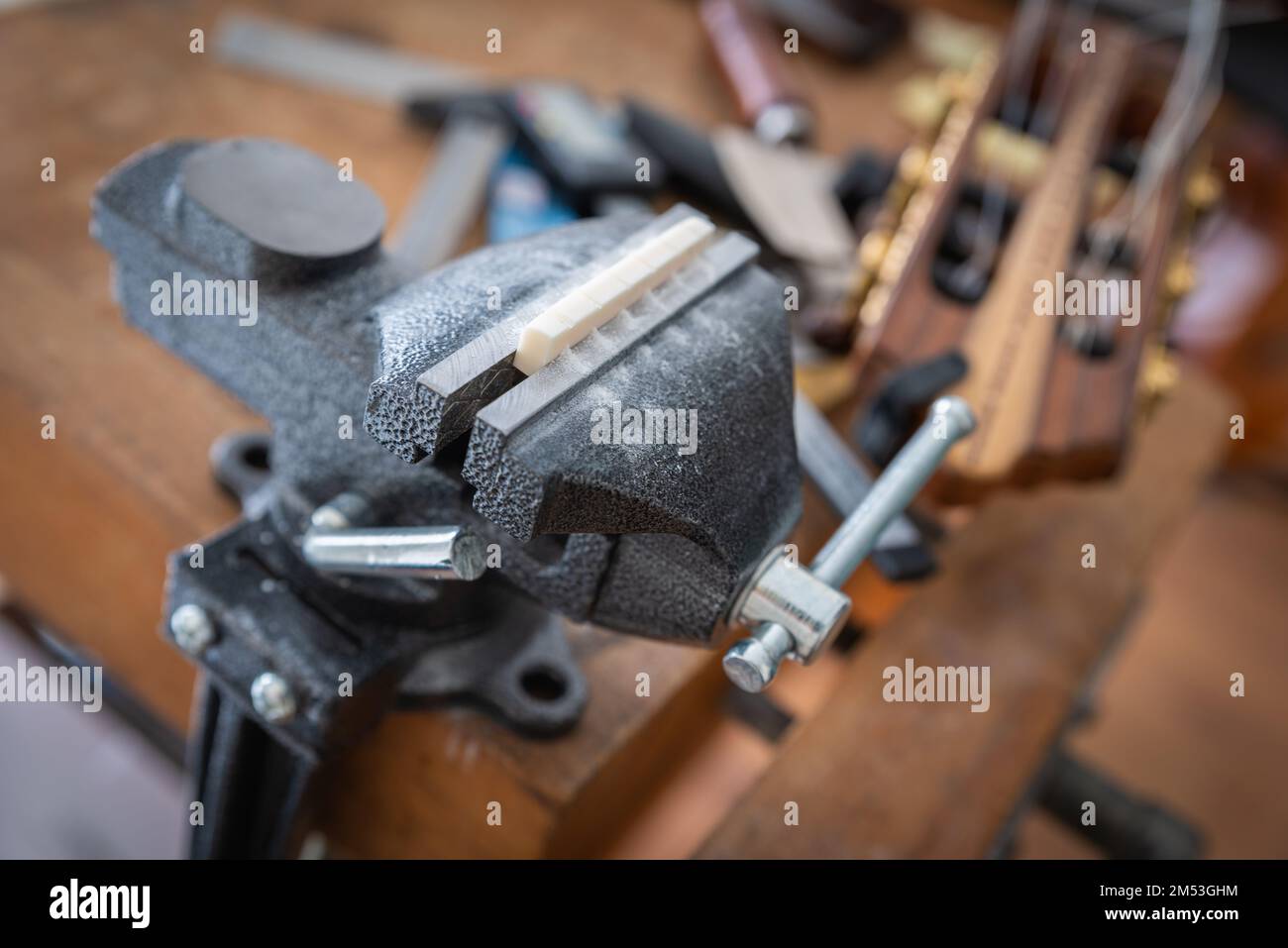 Musical instrument guitar repair and service guitar bone nut slotting