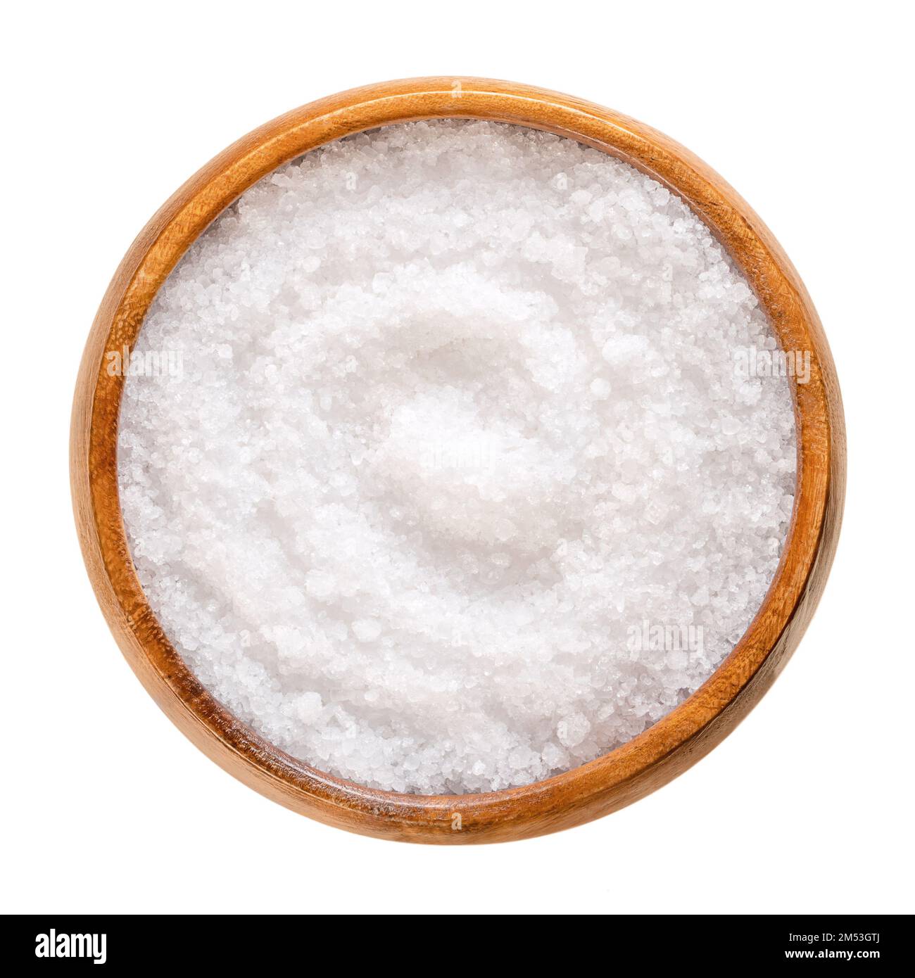 Fleur de sel, sea salt, in a wooden bowl. Also known as flor de sal, a salt that forms a thin, delicate crust on the sea water that evaporates. Stock Photo