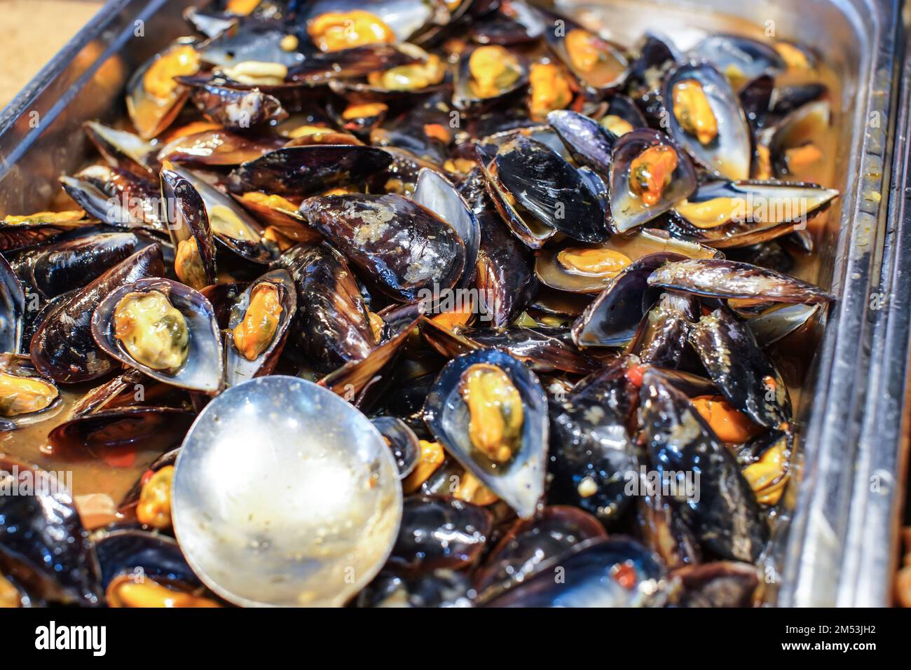 Black and yellow mussels at buffet restaurant, closeup detail Stock Photo