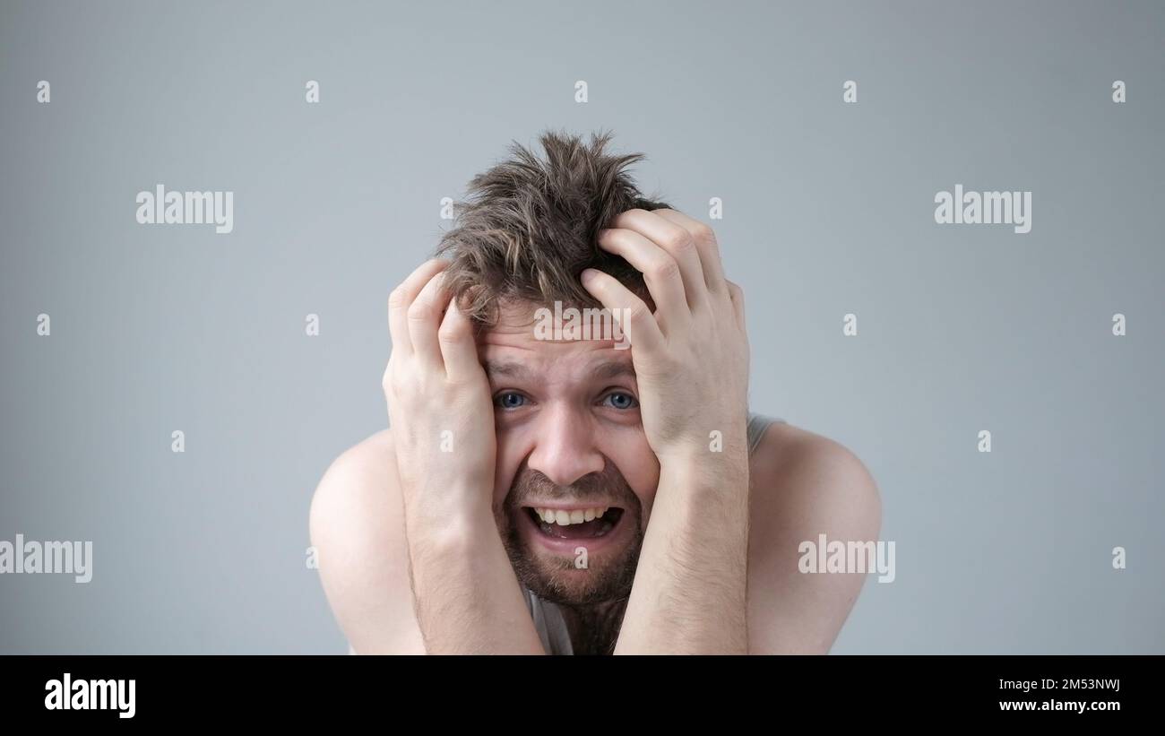 Scared caucasian guy shivering from fear, looking afraid and insecure