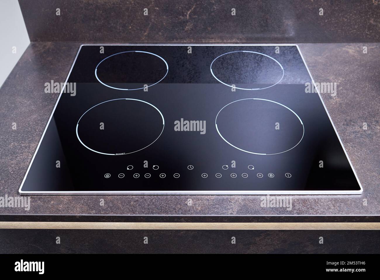 Grey countertop with black glossy built in ceramic glass induction or electric hob stove cooker