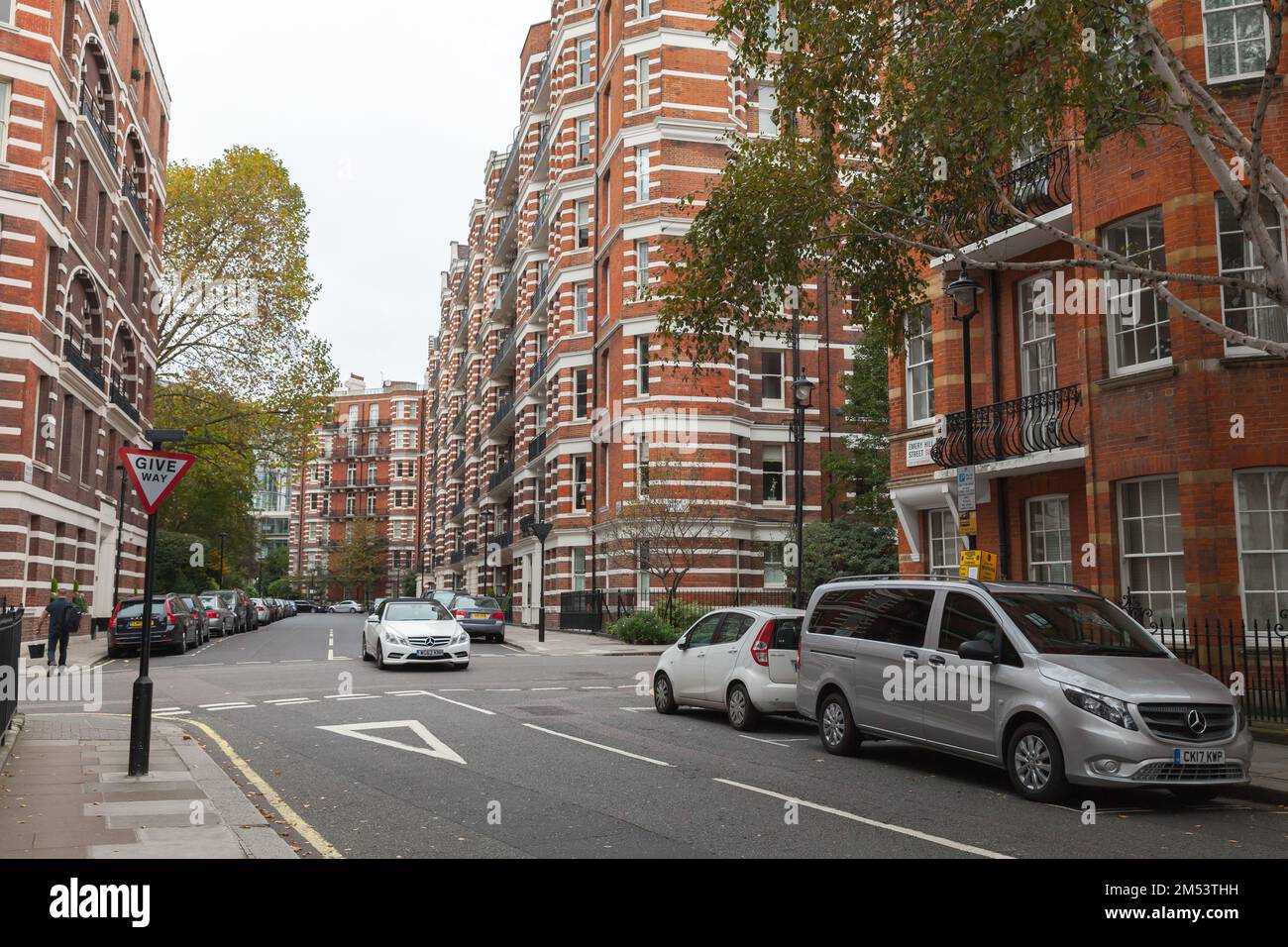 London, United Kingdom - October 31, 2017: London Street view, people walk the street near parked cars Stock Photo