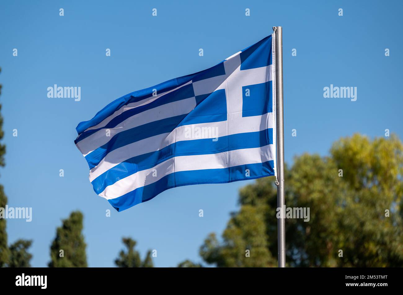 Greek flag flying from a pole Stock Photo