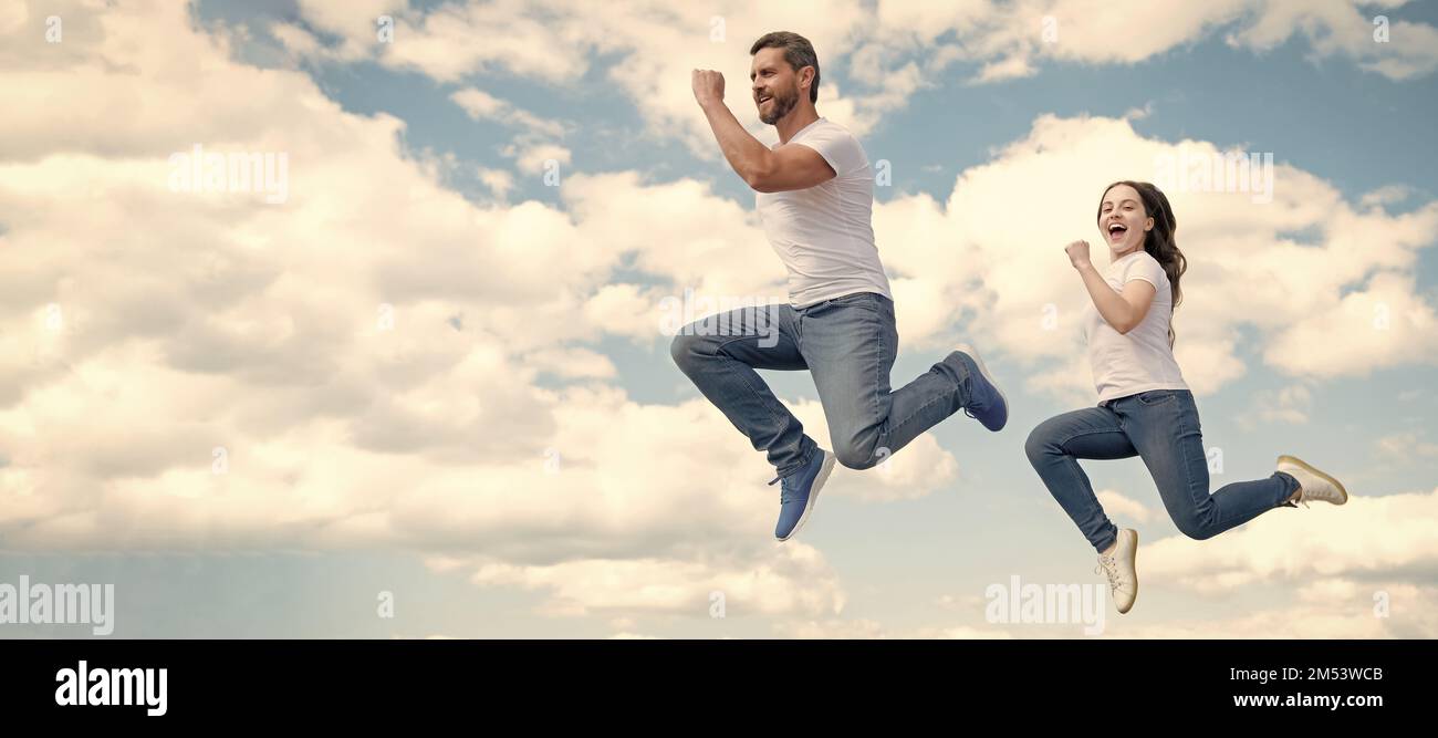 Father and daughter jump on sky, banner with copy space. happy father ...