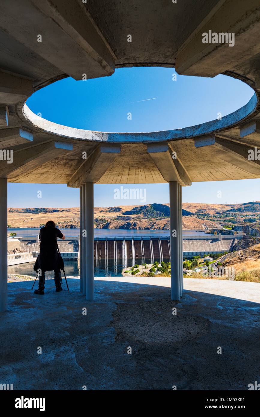Visitor photographing Grand Coulee hydroelectric dam; largest producer