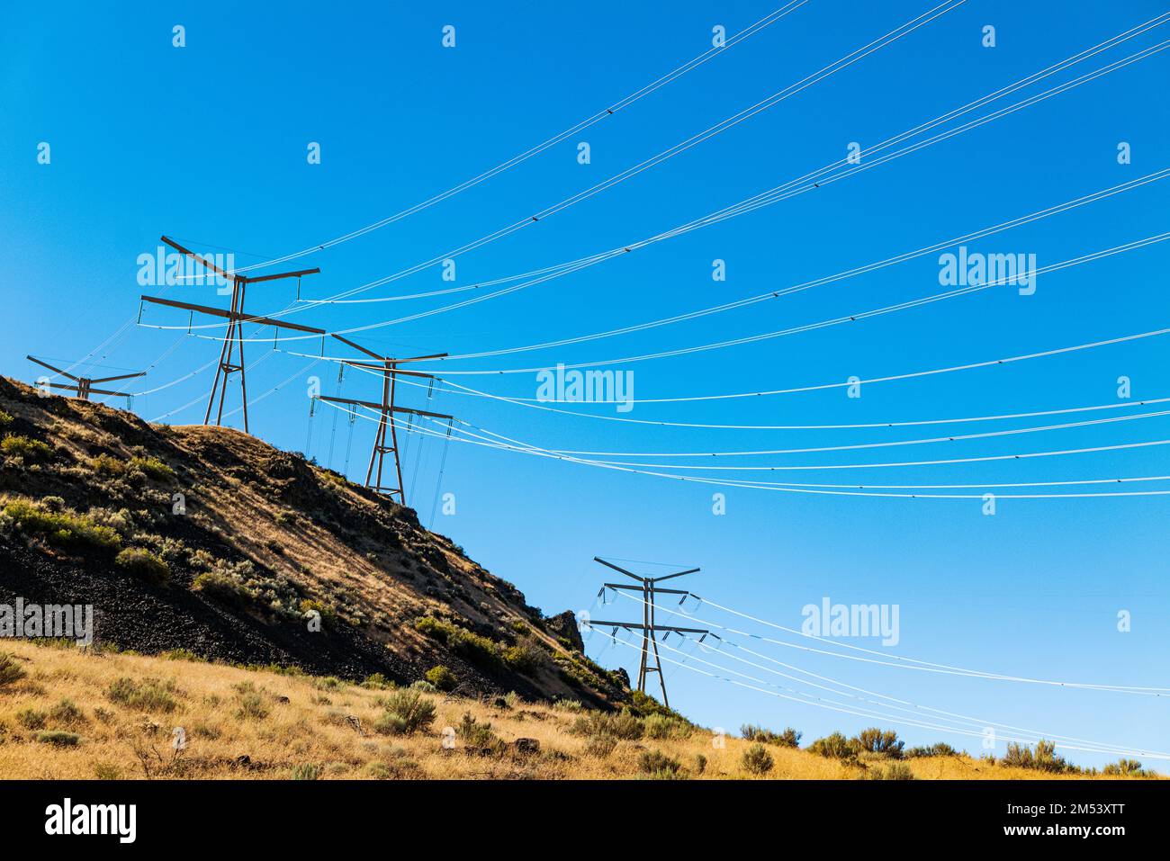 Electrical transmission lines run from Grand Coulee hydroelectric dam; largest producer of power in the USA; Columbia River; Washington state; USA Stock Photo