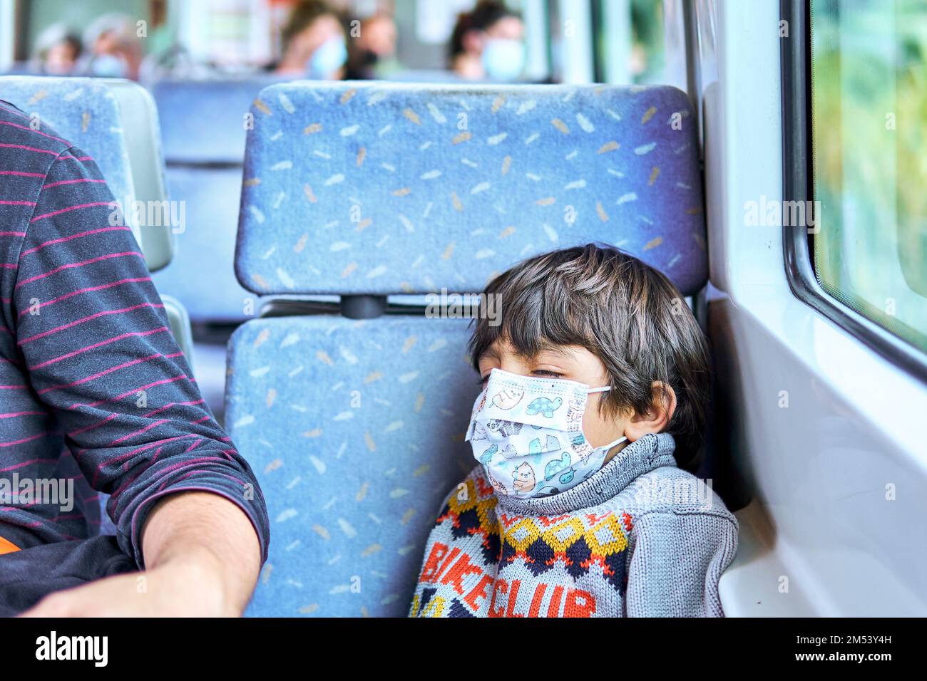 kid with face mask sleeping in a train Stock Photo Alamy