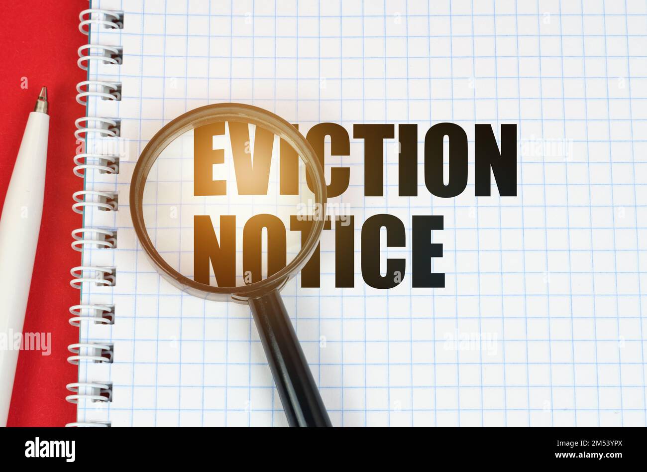 Business and finance concept. On the red surface is a pen, a notepad with the inscription