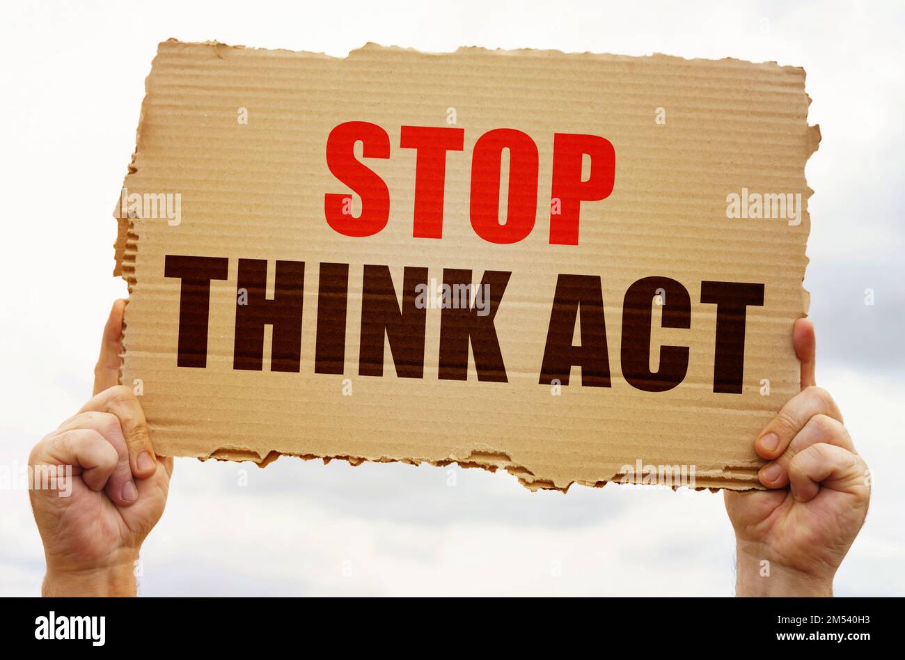 Business concept. In the hands of a man is a cardboard sign with the inscription - Stop Think Act Stock Photo