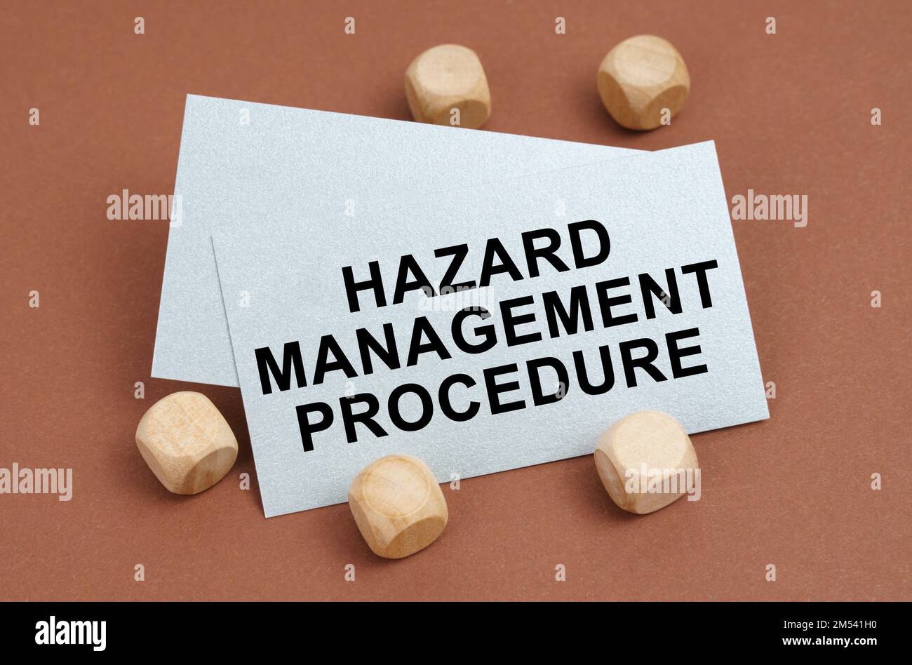 The concept of industrial safety. On a brown surface, wooden cubes and a business card with the inscription - Hazard Management Procedure Stock Photo