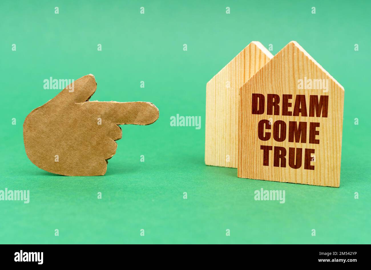 Business real estate concept. On a green surface, a hand points to a