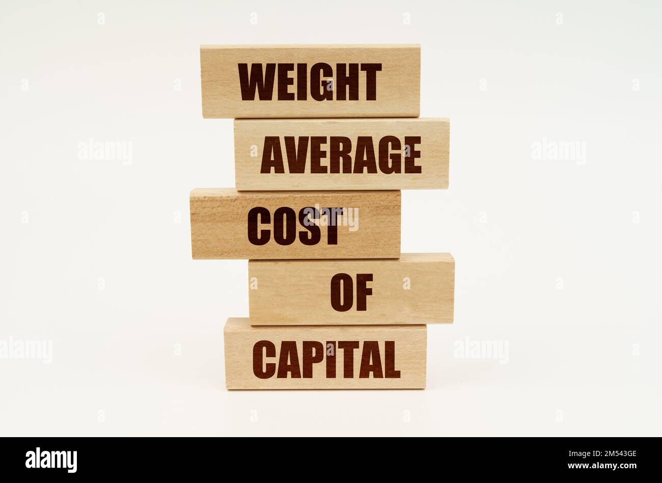 Business concept. On a white surface are wooden blocks with the inscription - WEIGHT AVERAGE COST OF CAPITAL Stock Photo