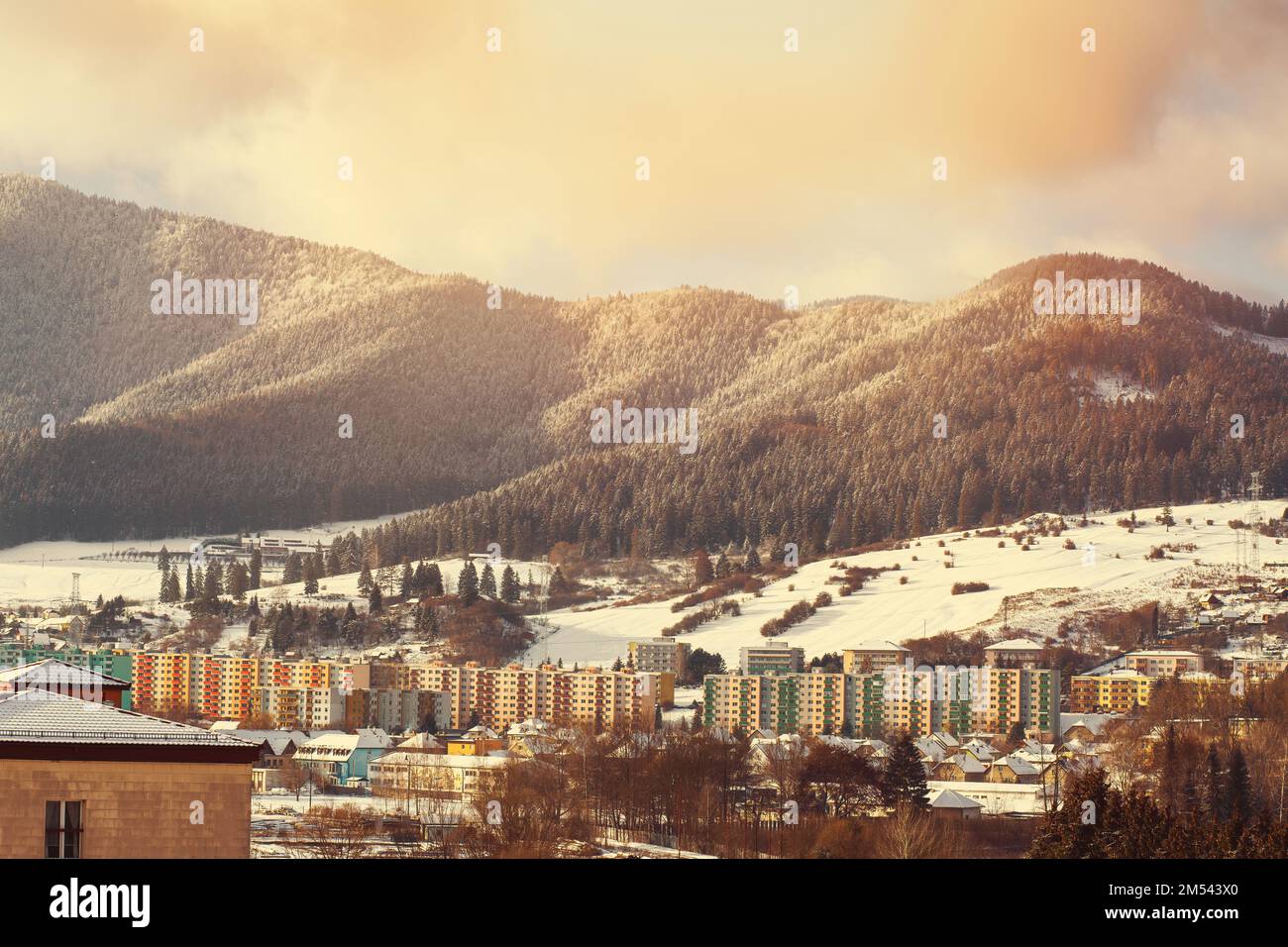 View of a town in winter season.Beautiful snowy mountains in background. Stock Photo