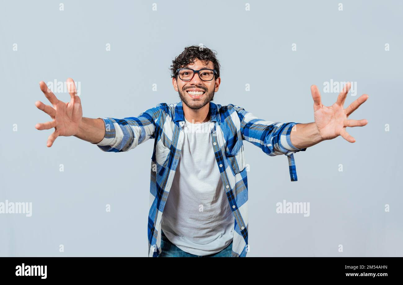 Man welcoming with open arms isolated. Friendly person welcoming. Generous young man with open arms isolated, Man sharing with open hands looking at Stock Photo