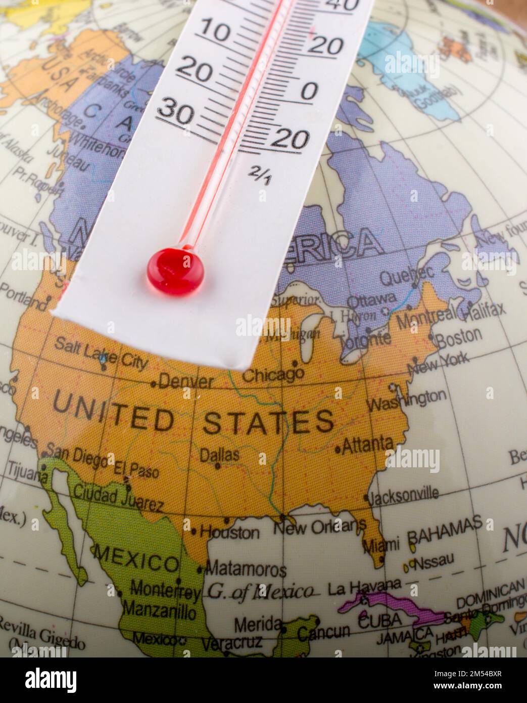 Thermometer placed on a little model globe Stock Photo Alamy