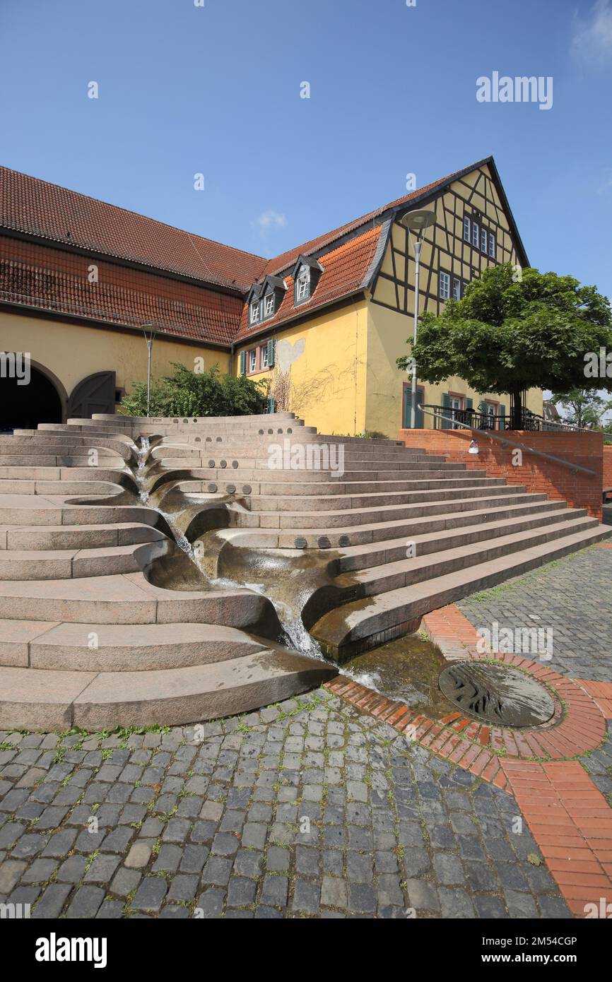 Market square and fountain with water features and half-timbered house Alter Posthof, Hattersheim, Taunus, Hesse, Germany Stock Photo
