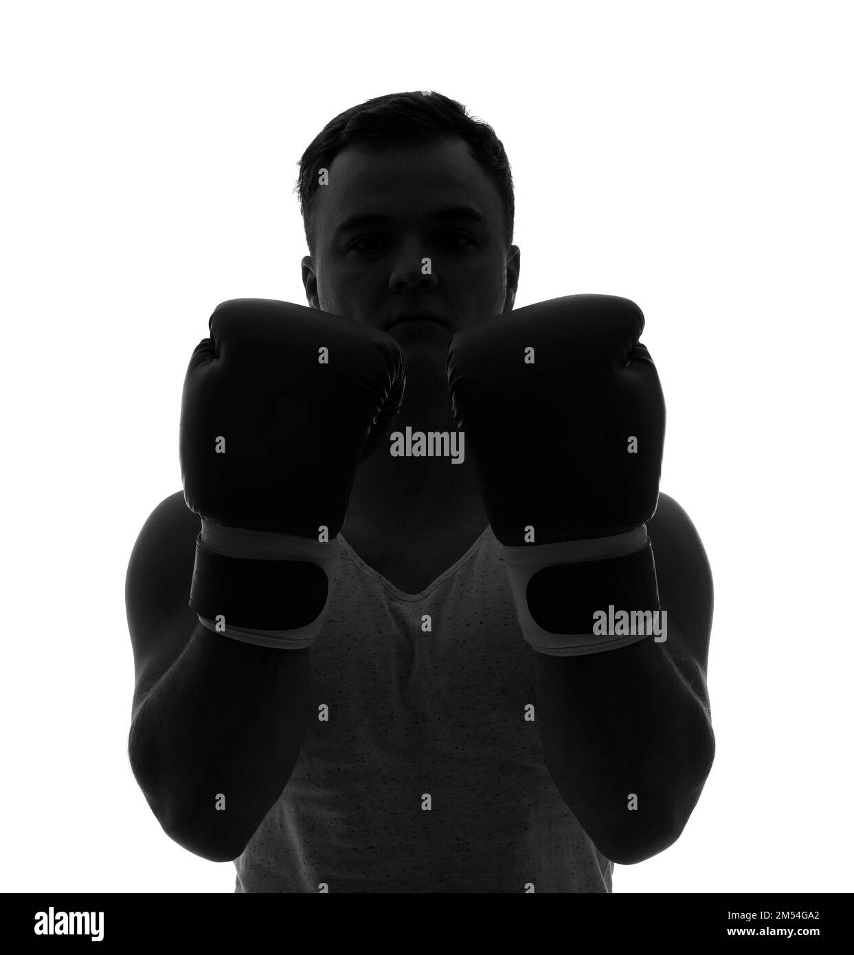 Silhouette of sporty young man in boxing gloves on white background