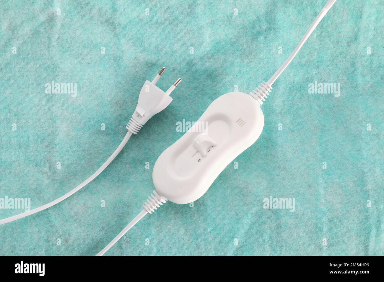 Controller and plug on electric heating pad, closeup Stock Photo