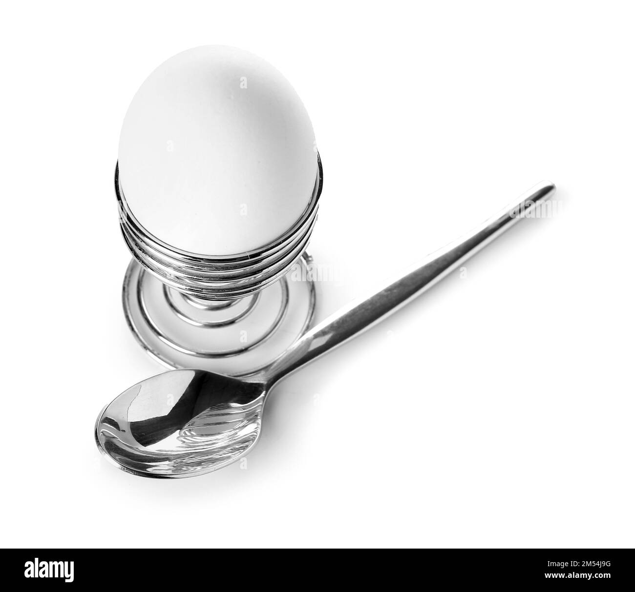 Egg in holder and spoon on white background Stock Photo