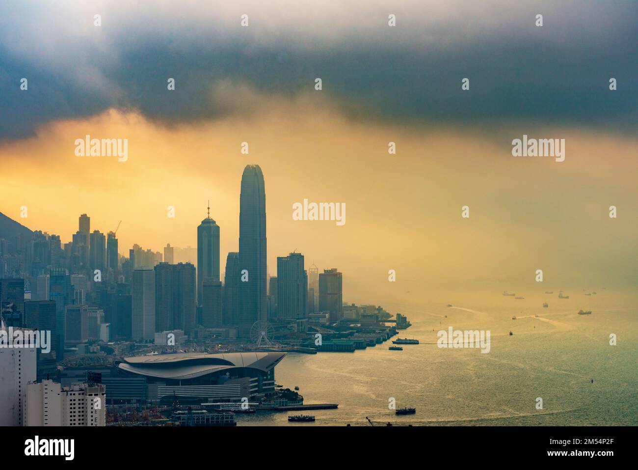 An approaching storm combines with smog to shroud the Hong Kong Island skyline, 2016 Stock Photo