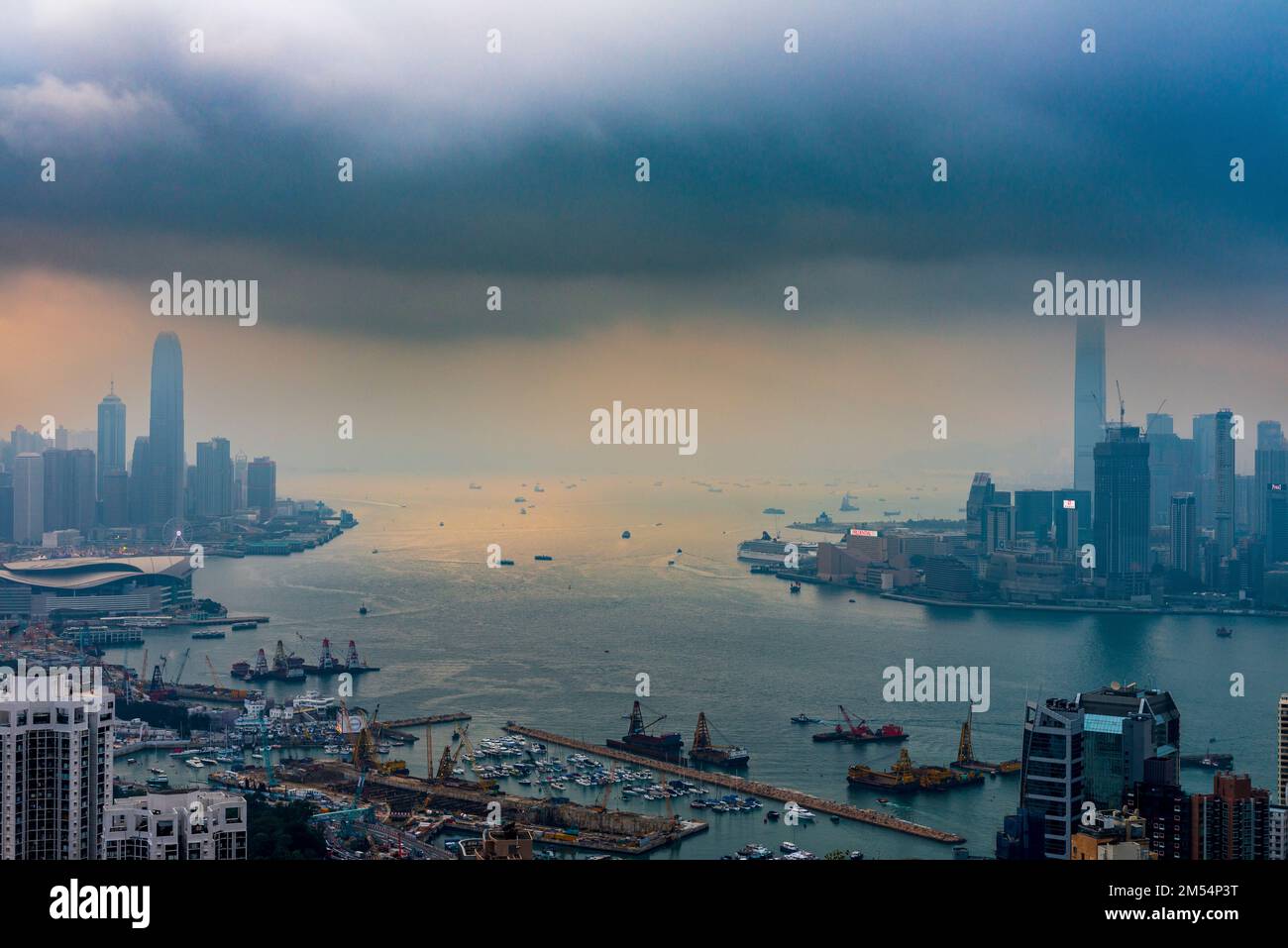 An approaching storm combines with smog to shroud the Hong Kong skyline, 2016 Stock Photo