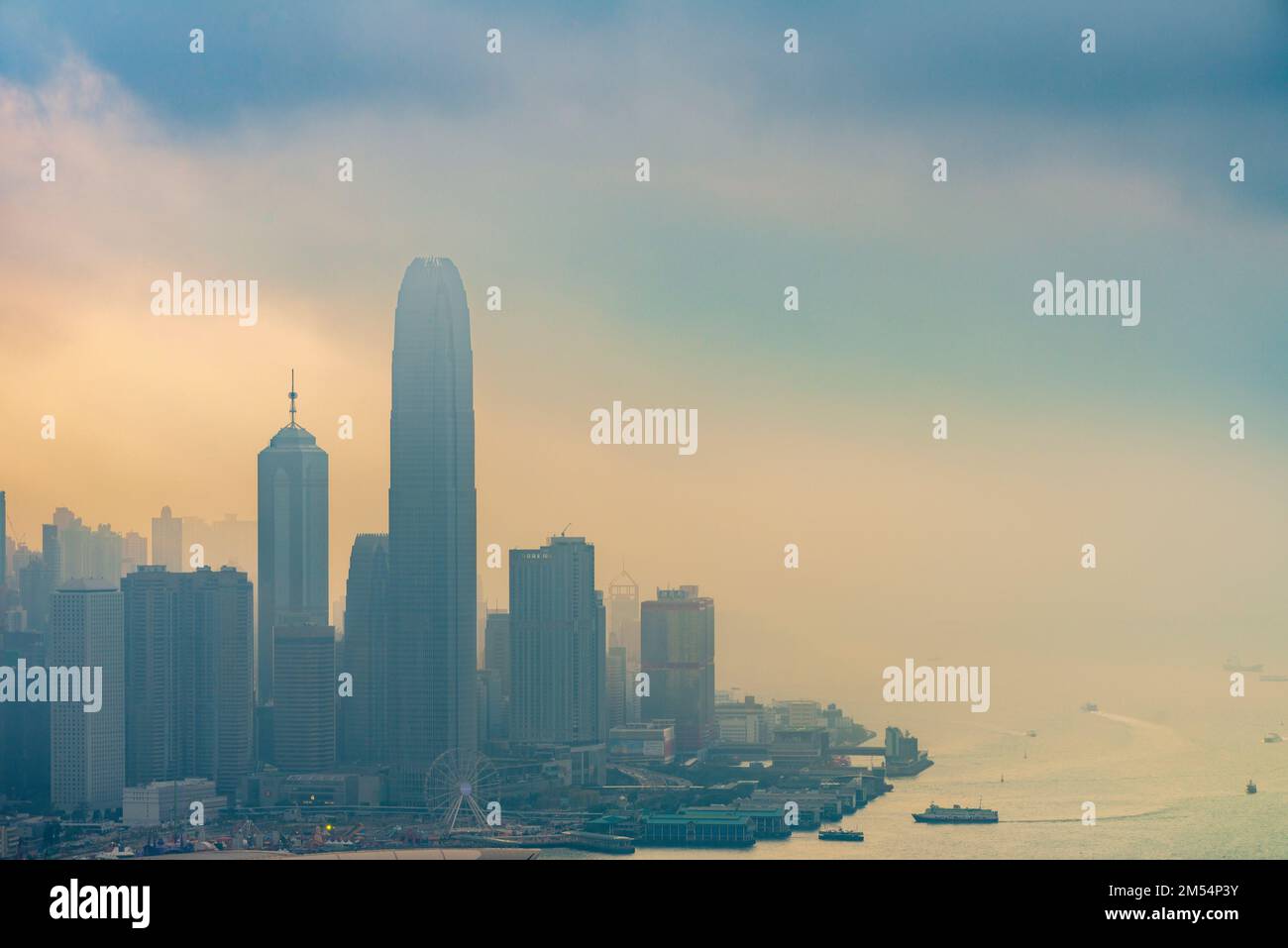 Sea mist ahead of an approaching storm combines with smog to shroud the Hong Kong Island skyline, 2016 Stock Photo