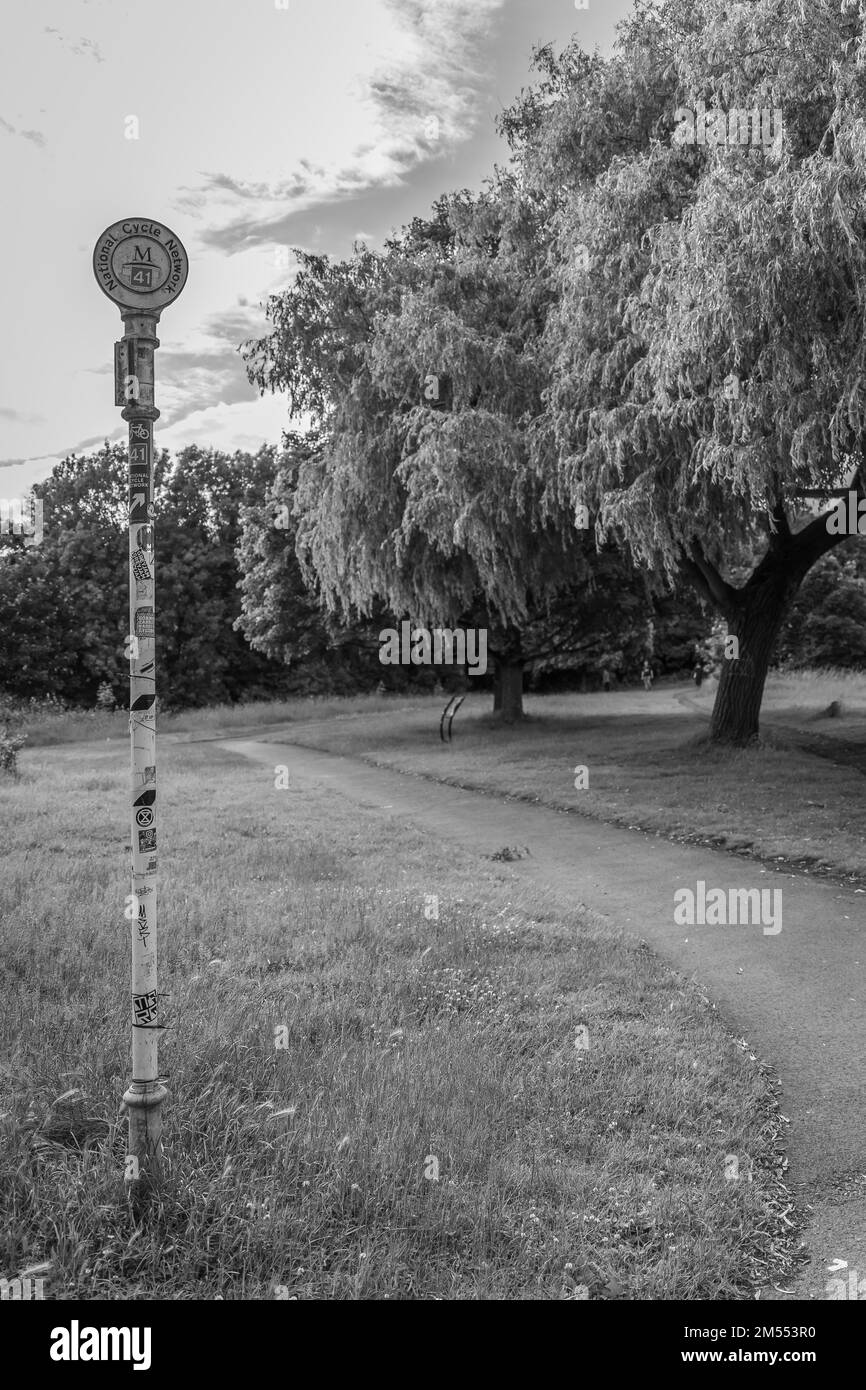A vertical grayscale of a pole sign in the National cycle route in ...