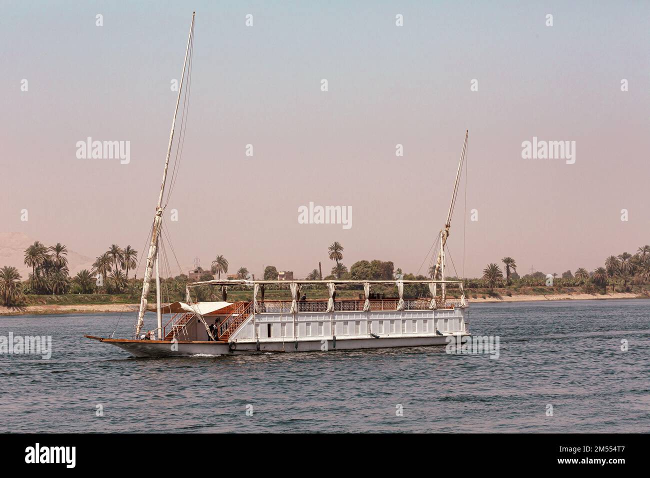 Felucca (river boat) on the Nile, with the Sahara behind in Aswan, Egipt. Stock Photo