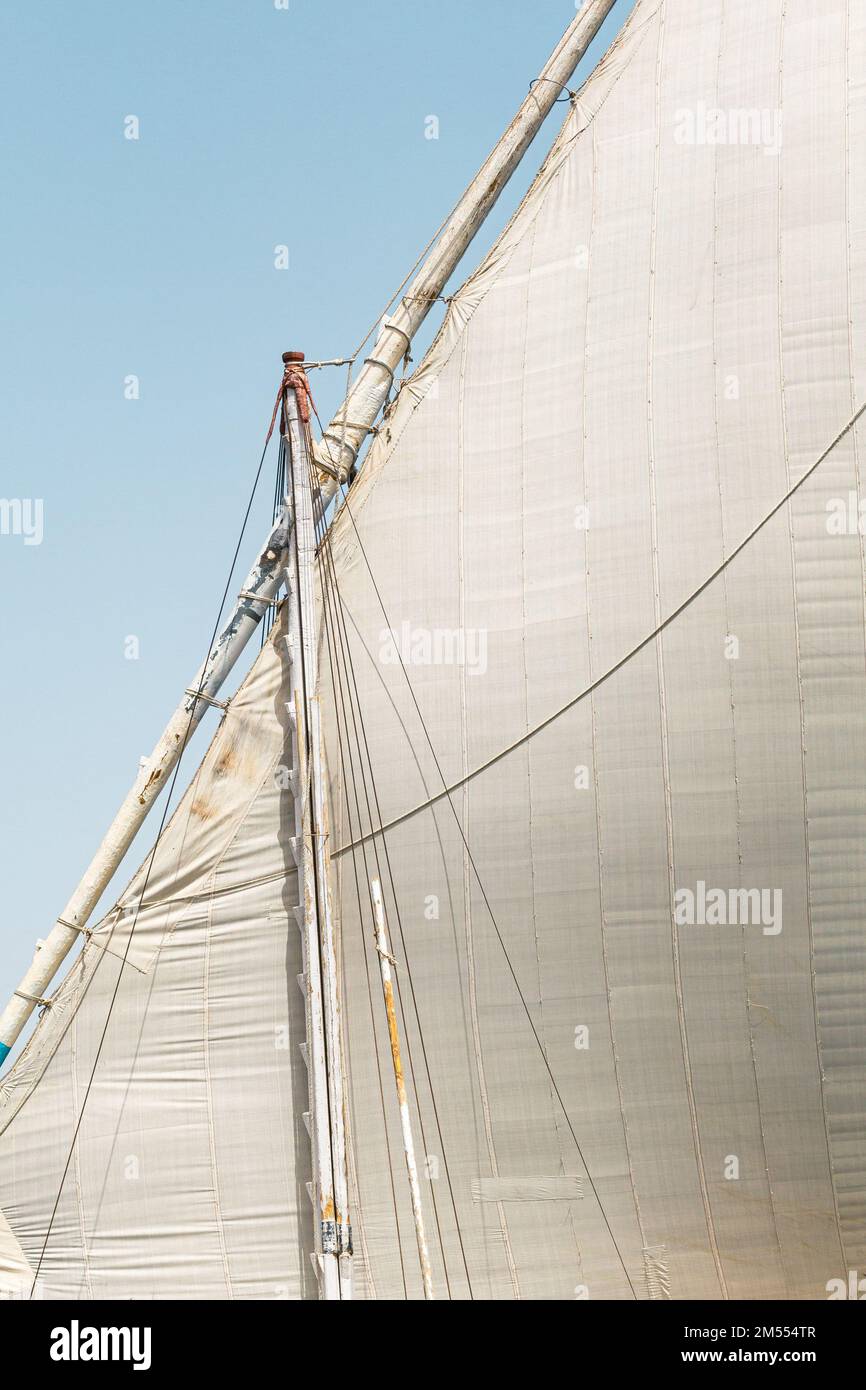 Felucca (river boat) on the Nile, with the Sahara behind in Aswan, Egipt. Stock Photo