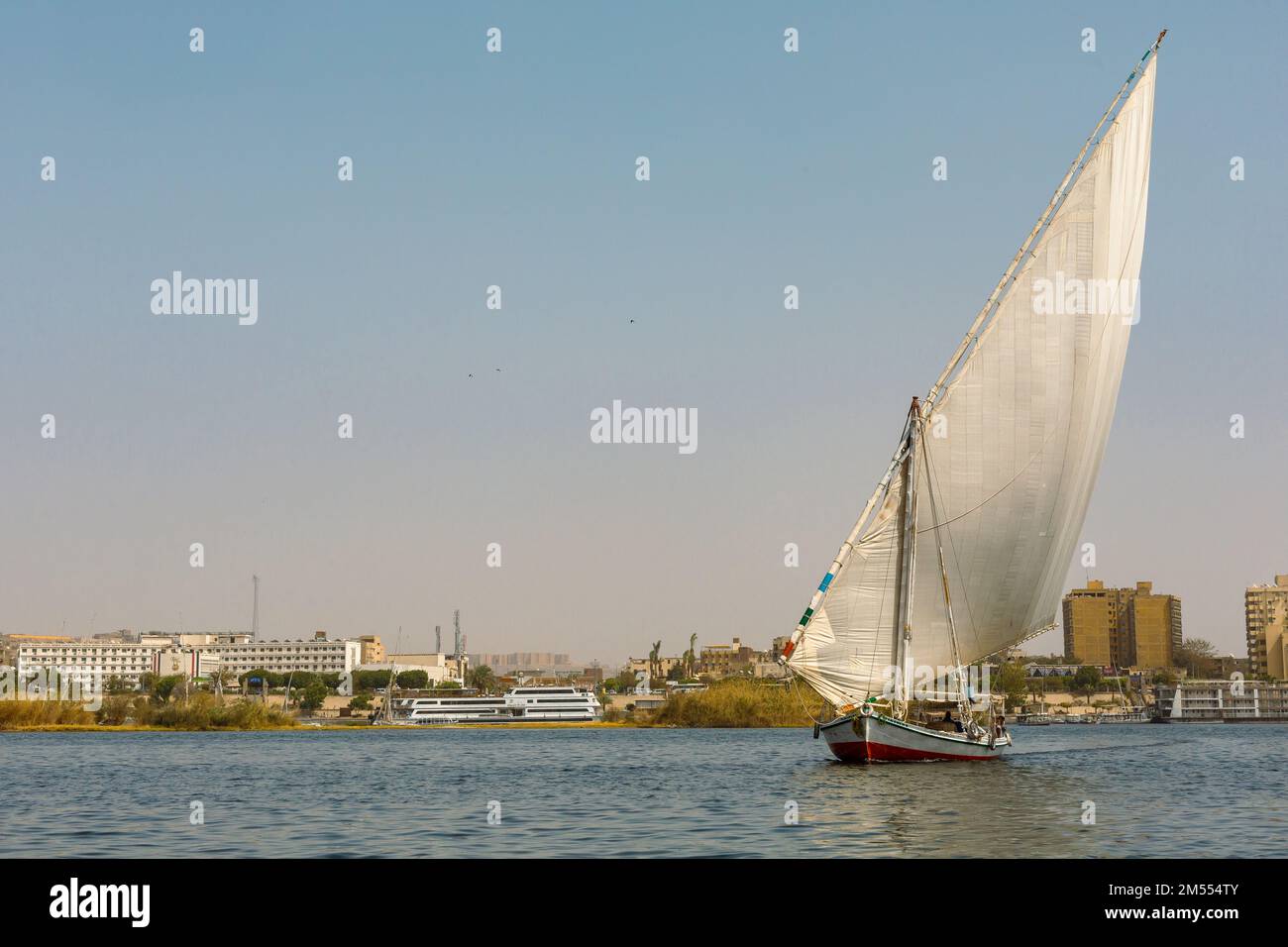 Felucca (river boat) on the Nile, with the Sahara behind in Aswan, Egipt. Stock Photo