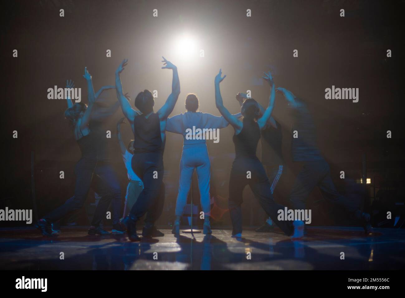 artist on stage in the rays of light Stock Photo - Alamy