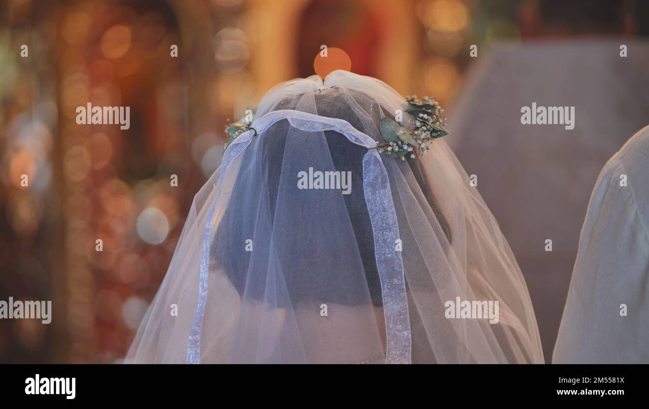 Veil and wreath close-up on the bride during the wedding. Stock Photo