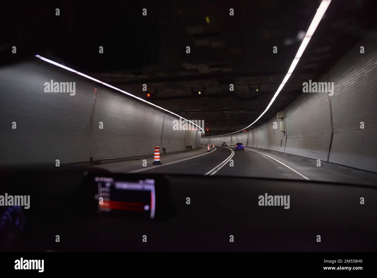 Cars in a tunnel. night drive with car in motion through the city shows through a tunnel. Stock Photo