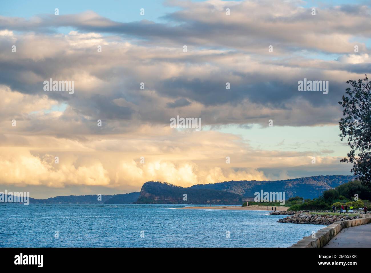 Large puffy and colourful clouds rolling north towards Ettalong Beach across Broken Bay and Lion Island from West Head in Sydney, Australia Stock Photo