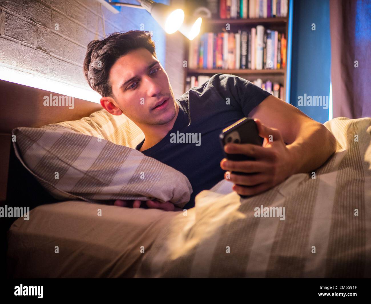 Man checking notification on smartphone at night Stock Photo