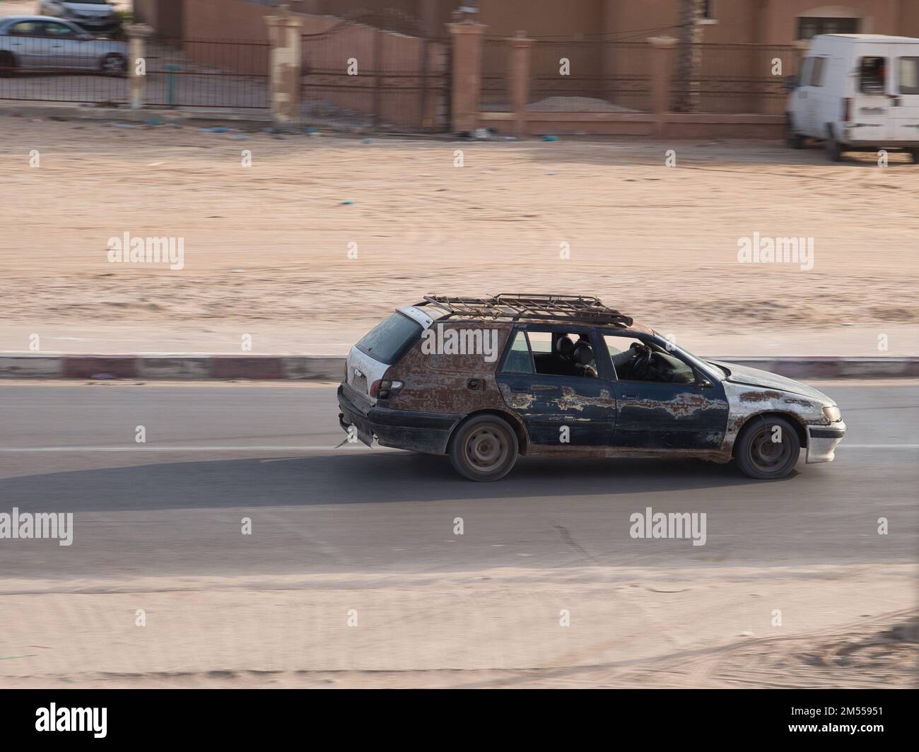 An old rusted car on the road in Nouakchott, Mauritania Stock Photo - Alamy