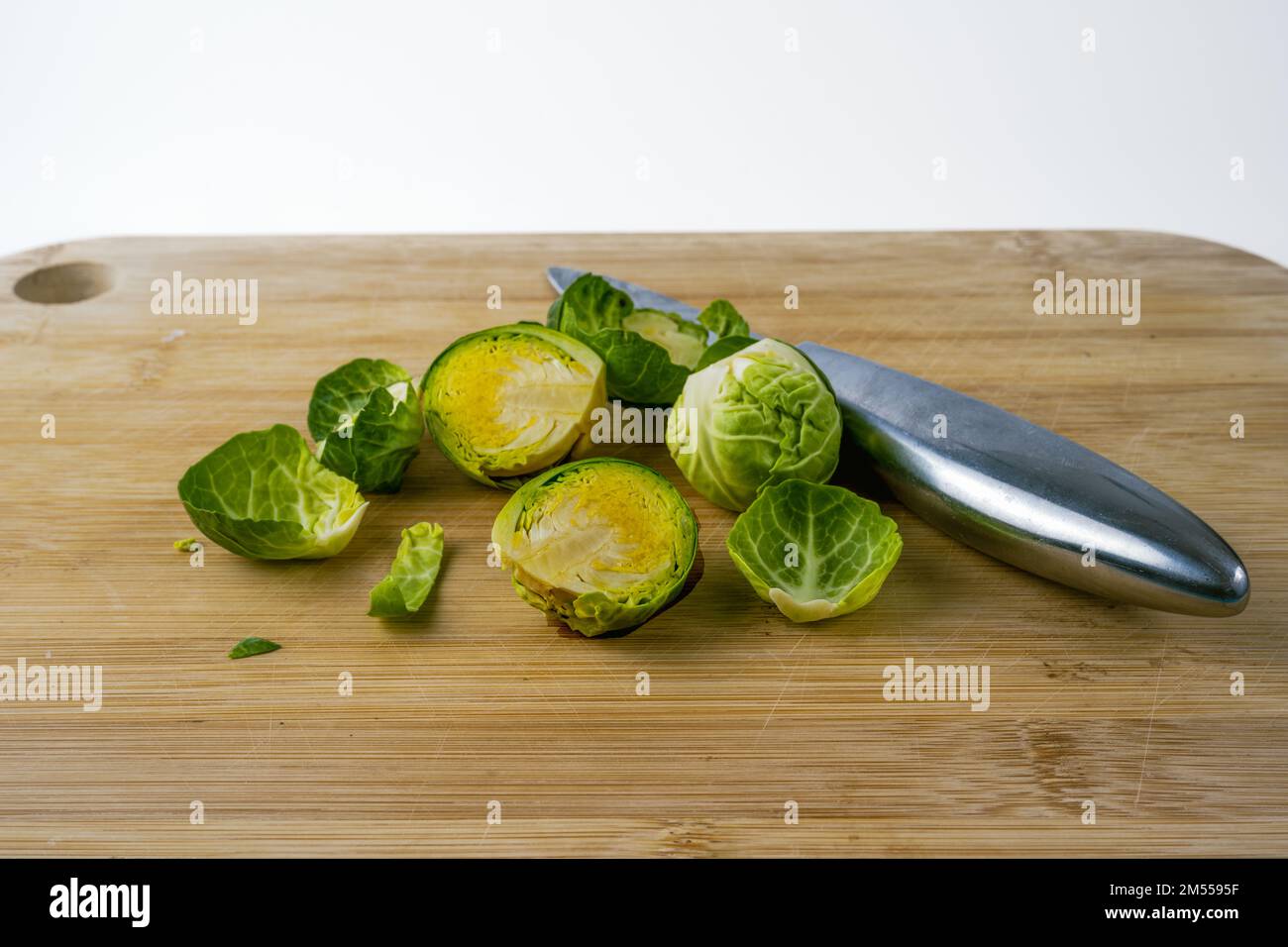 bamboo chopping board with knife and brussel sprouts Stock Photo Alamy