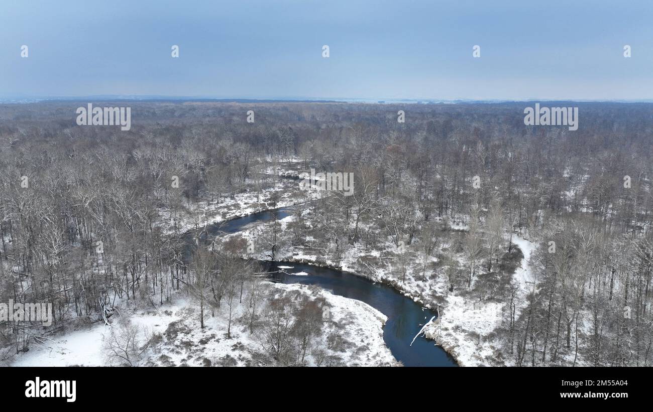 River delta floodplain winter snow meander drone aerial inland video shot in sandy sand alluvium freezing cold frost, benches forest and lowlands wetl Stock Photo