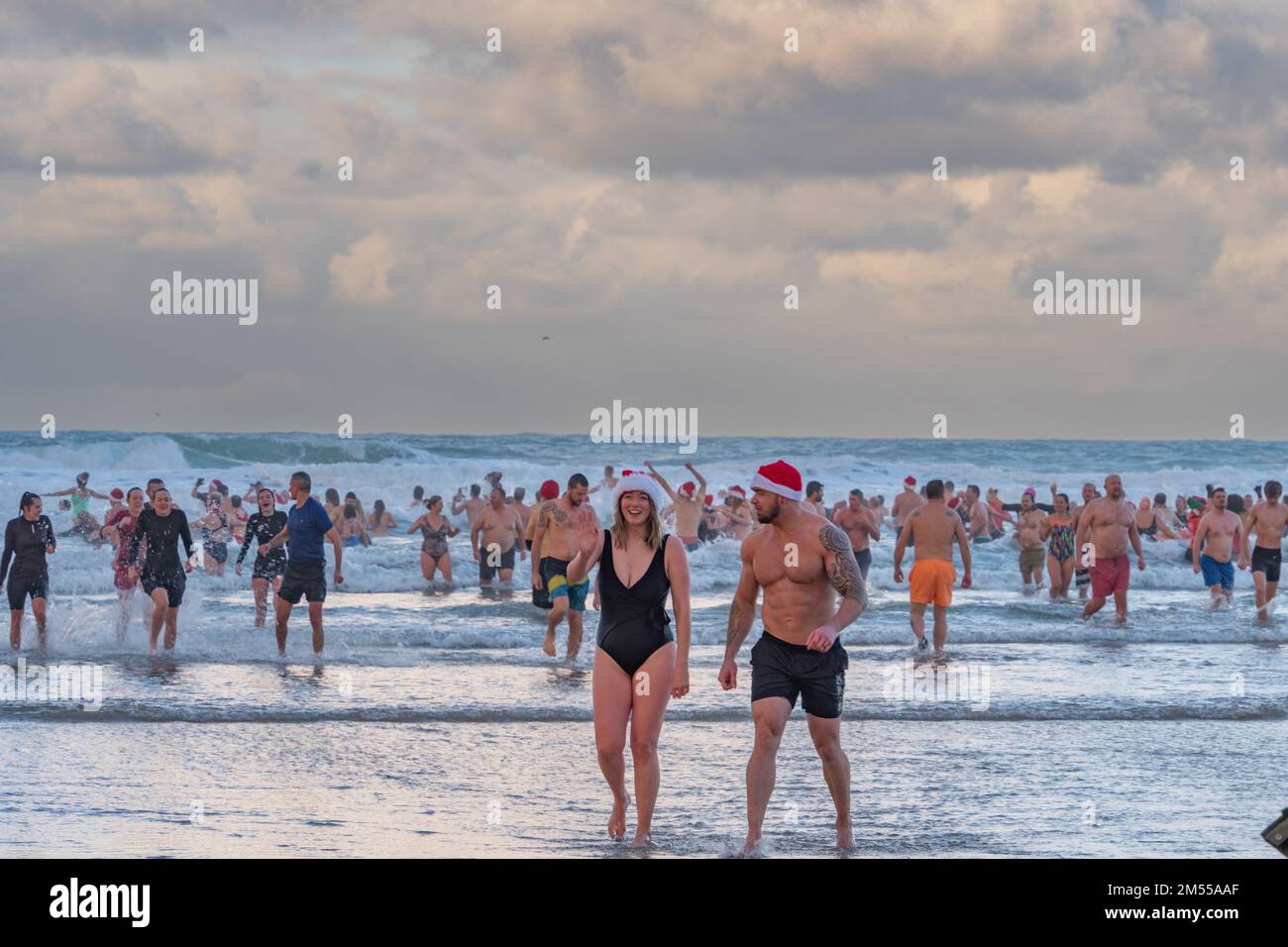 Perranporth, Cornwall, UK. 26th December 2022. UK Weather. Hundreds of people took part in the traditional boxing day swim at Perranport in Cornwall. Credit Simon Maycock / Alamy Live News. Stock Photo