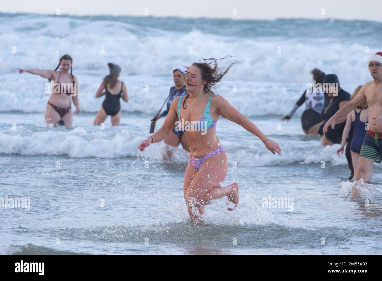 Perranporth, Cornwall, UK. 26th December 2022. UK Weather. Hundreds of people took part in the traditional boxing day swim at Perranport in Cornwall. Credit Simon Maycock / Alamy Live News. Stock Photo