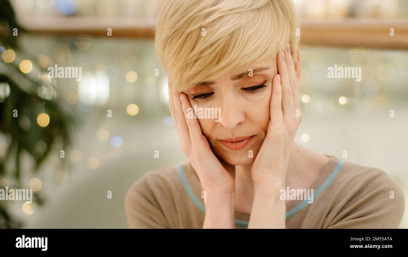 Sad middle aged caucasian woman 40s lady feel depressed problems. Upset mature single female difficult thinking headache migraine divorce solitude Stock Photo