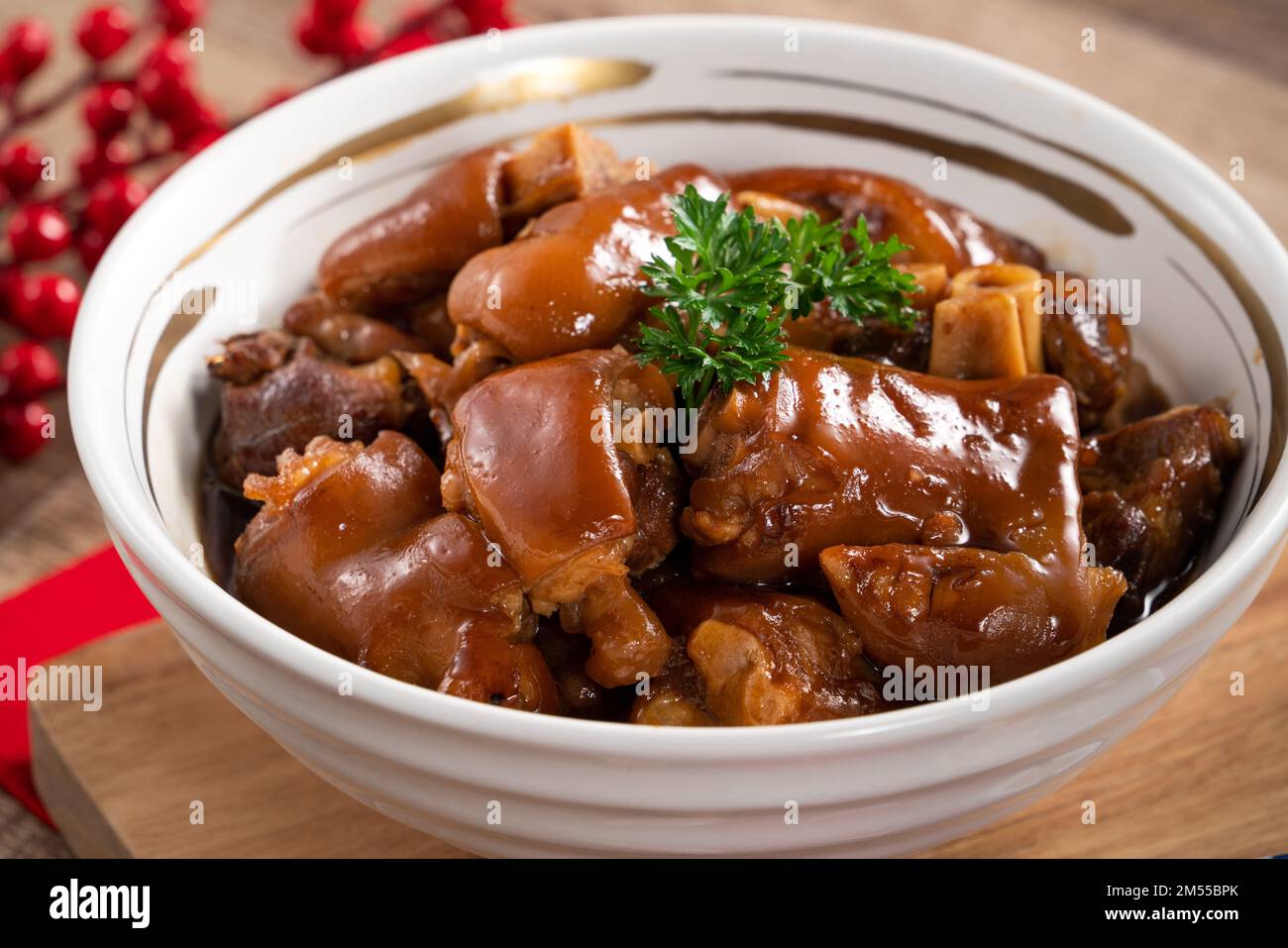 Taiwanese traditional food pork knuckle in a white bowl with golden