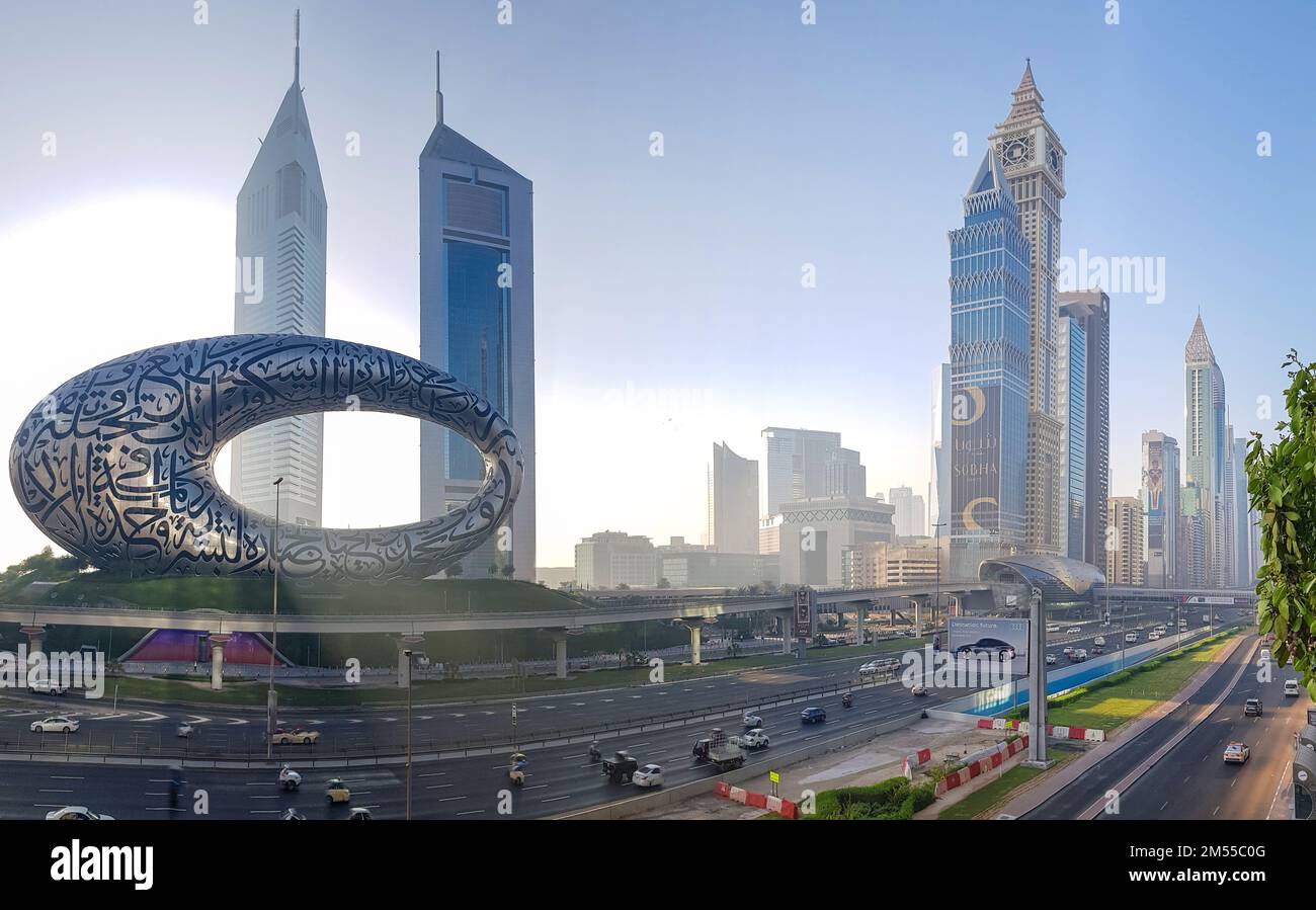 Dubai, UAE - November 27, 2021: Panoramic view of Museum of Future and Emirates towers buildings. Modern futuristic Museum built according designed by architect Shaun Killa. Stock Photo