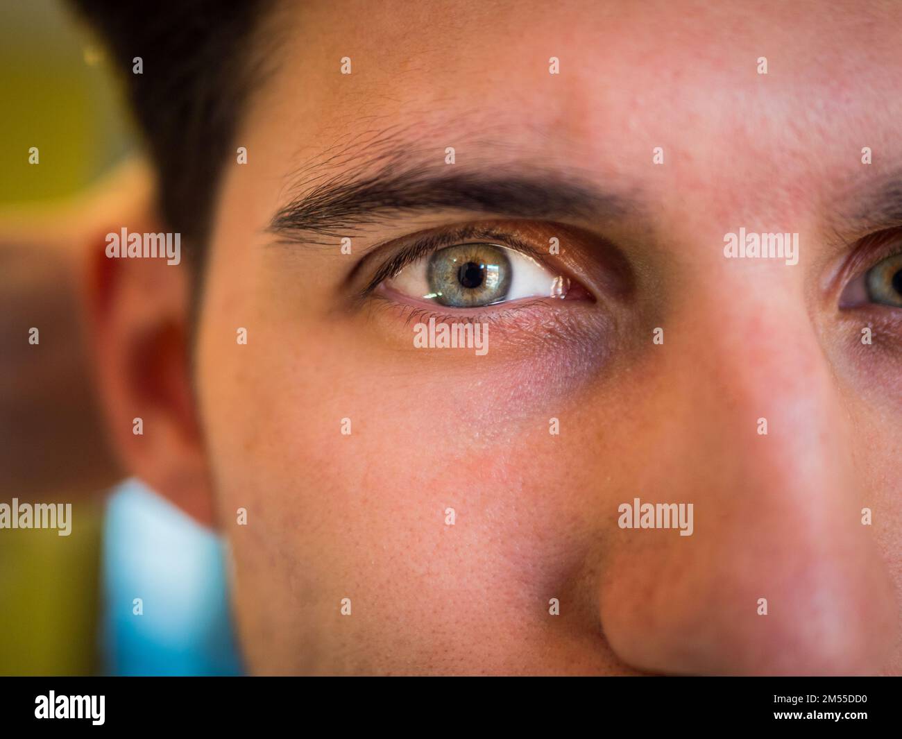 Close-up of attractive young man's green eye Stock Photo