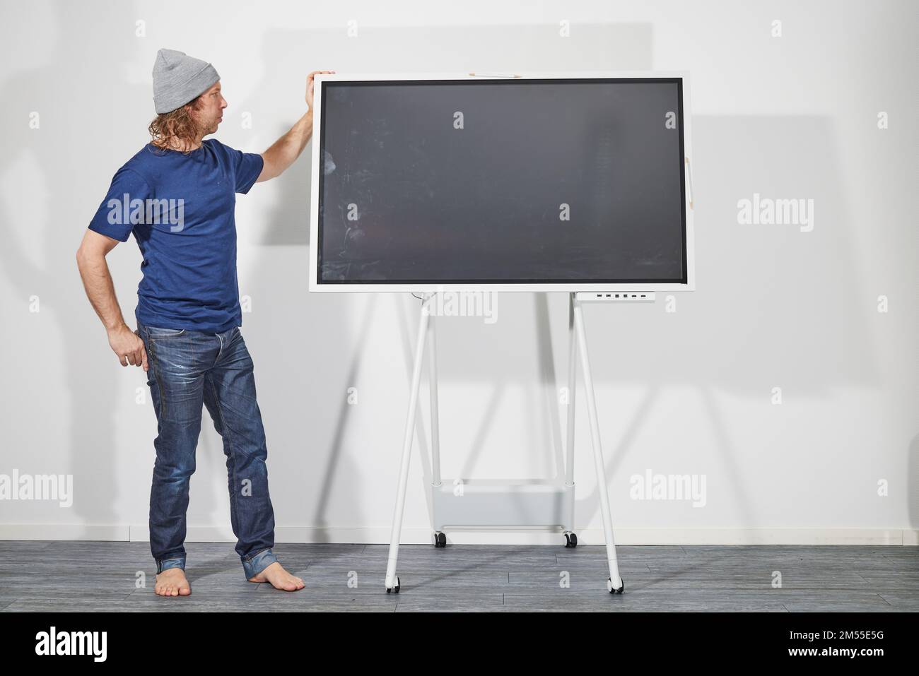Man presenting in front of digital screen Stock Photo