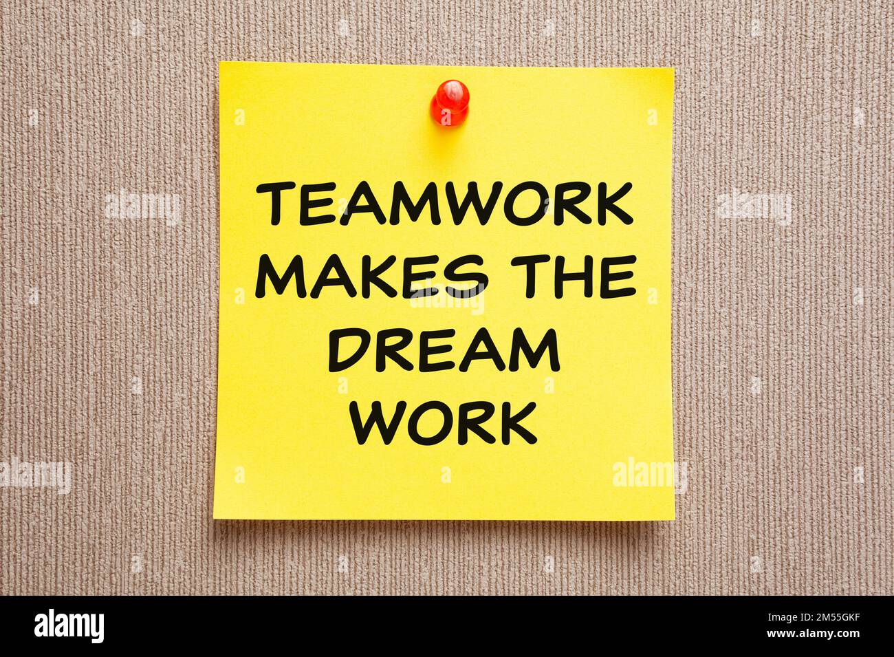 Motivational business quote Teamwork Makes The Dream Work written on a yellow sticky note. Stock Photo